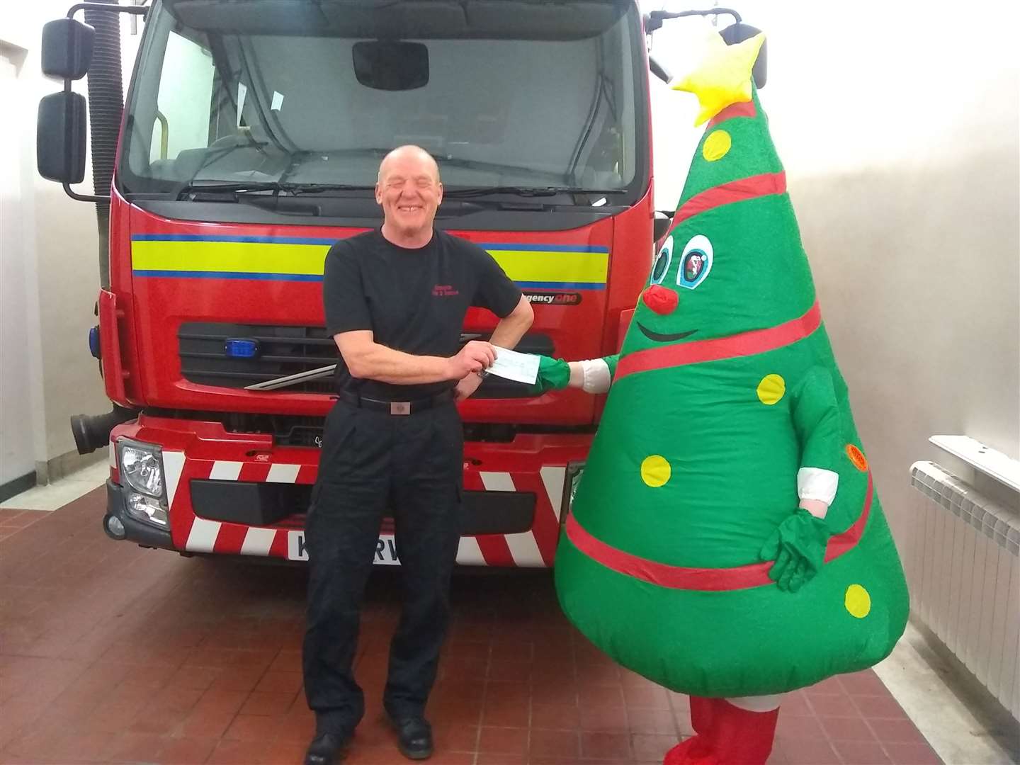 Moray Community Christmas’ mascot Sparkey (right) was donated by the Scottish Fire and Rescue Service and attends all of the dinners.