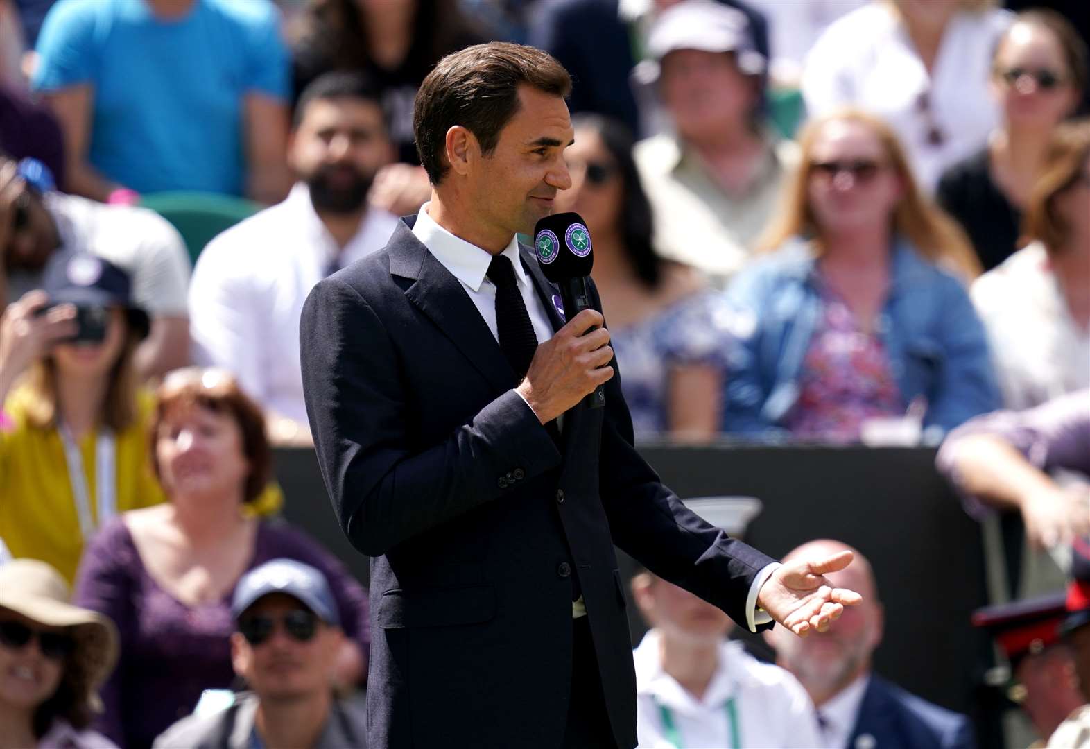 Roger Federer told spectators during a Centre Court centenary ceremony that he hopes to return to Wimbledon after recovering from his knee injury (John Walton/PA)