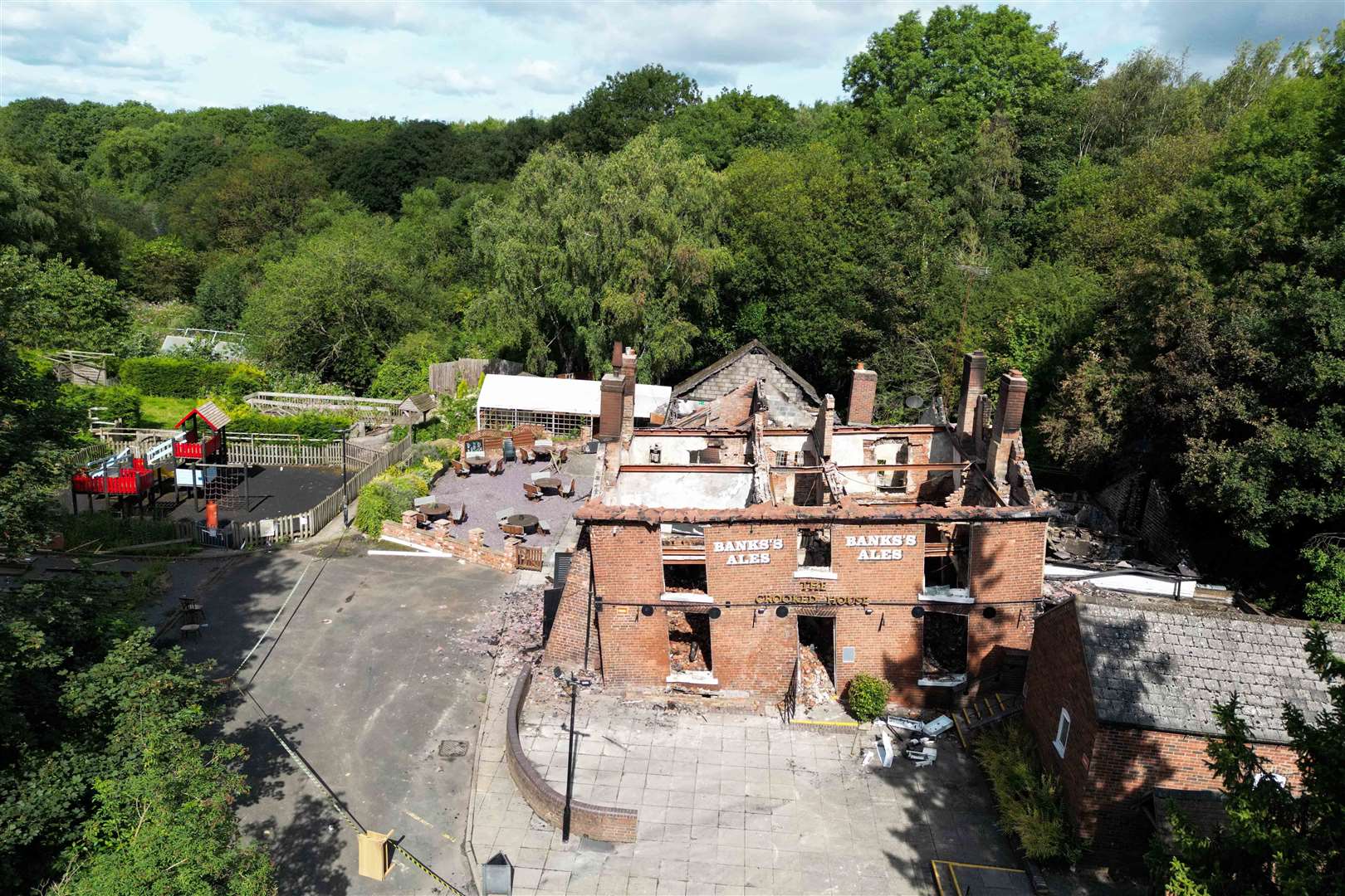 The burnt-out remains of the pub before its demolition (Jacob King/PA)