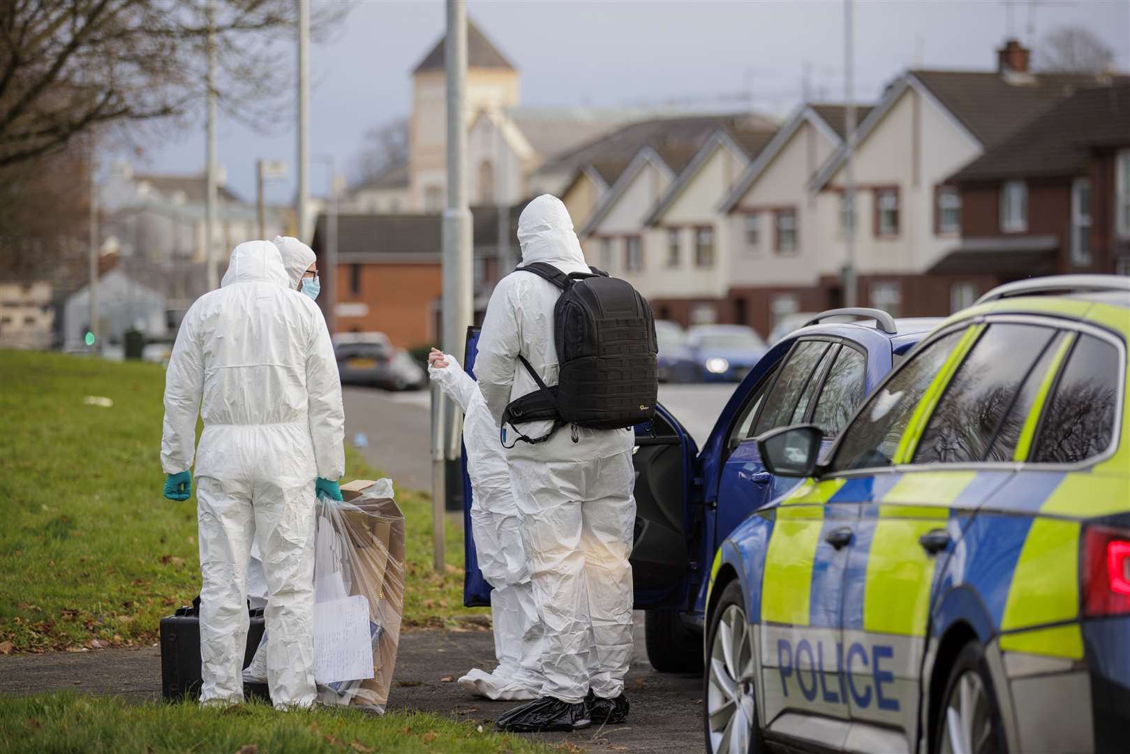 PSNI forensic officers at the Edward Street area of Lurgan, Co Armagh (Liam McBurney/PA)
