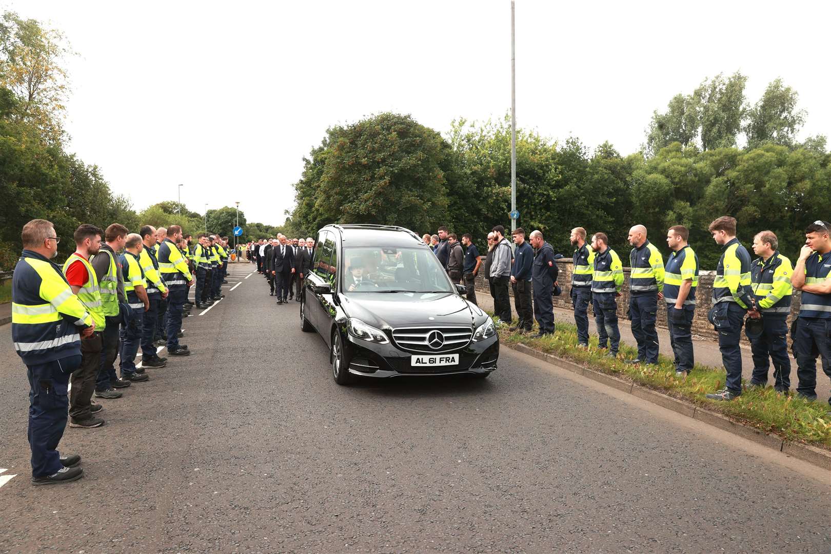 Employees formed a guard of honour to the funeral cortege of Sir William Wright (Liam McBurney/PA)
