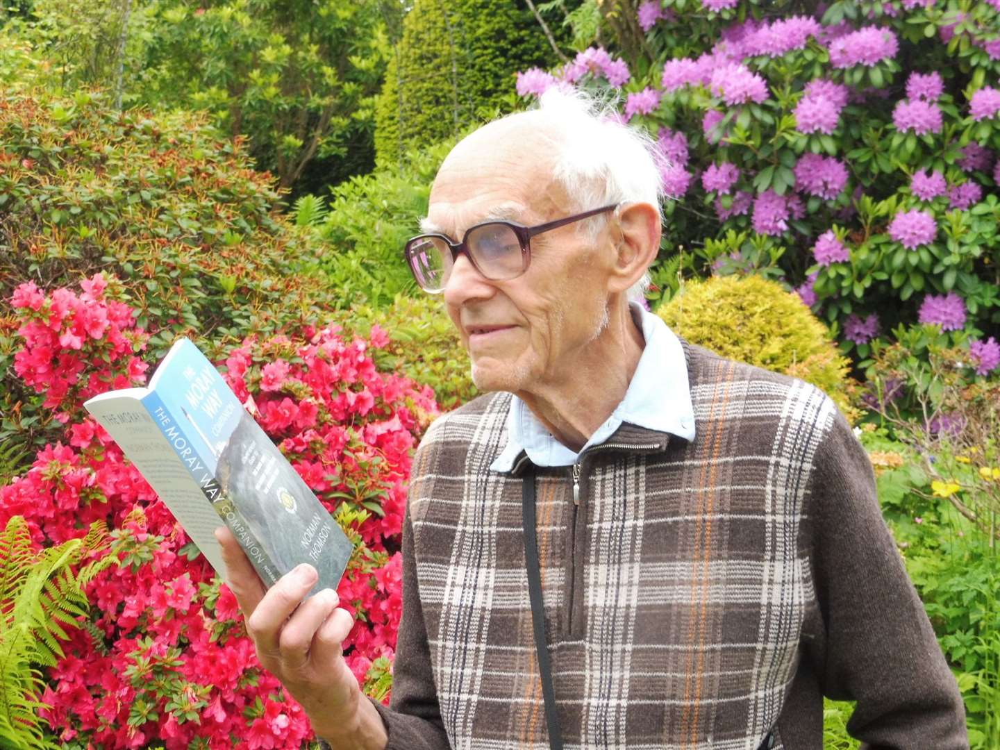 Author Norman Thomson with a copy of his new guide book, available at local bookshops.
