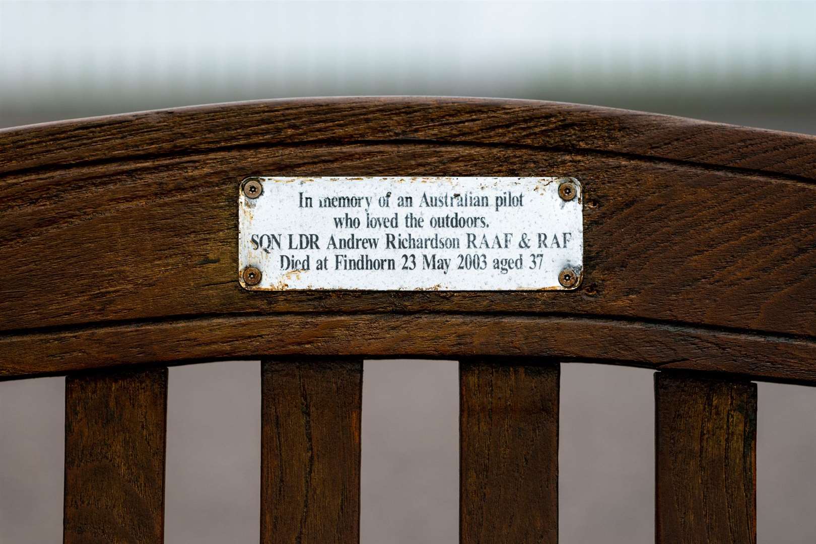 The inscription on the bench's plaque.