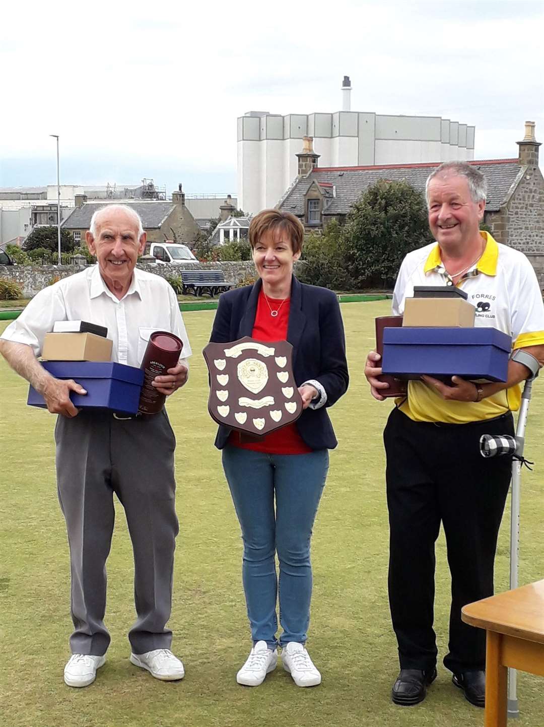 Stuart Roberton (left) and John Ross receive the Murray Cormie trophy from Audrey Christie, whose late father the tournament is held in memory of.