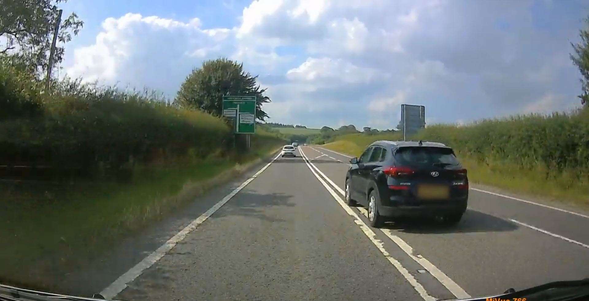 This motorist was caught on dashcam overtaking another car by crossing double white lines (Dorset Police/PA)