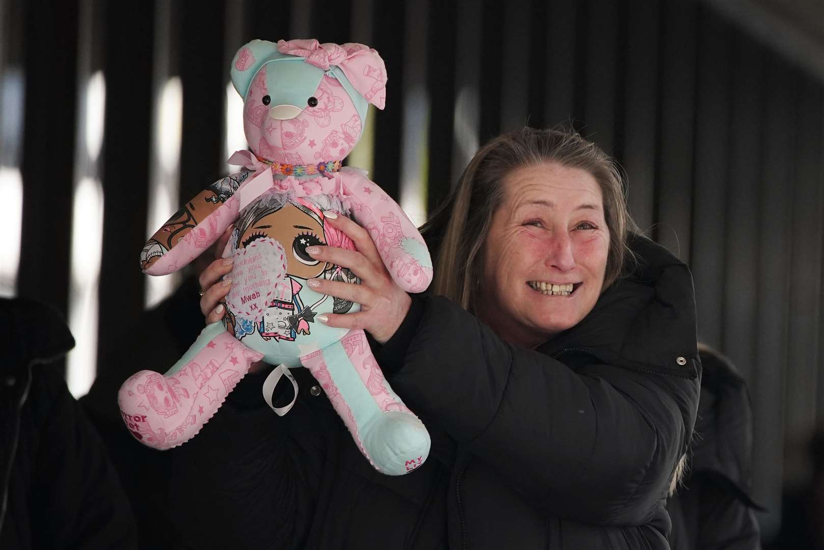Cheryl Korbel, mother of nine-year-old Olivia, holding a teddy bear outside Manchester Crown Court (Peter Byrne/PA)