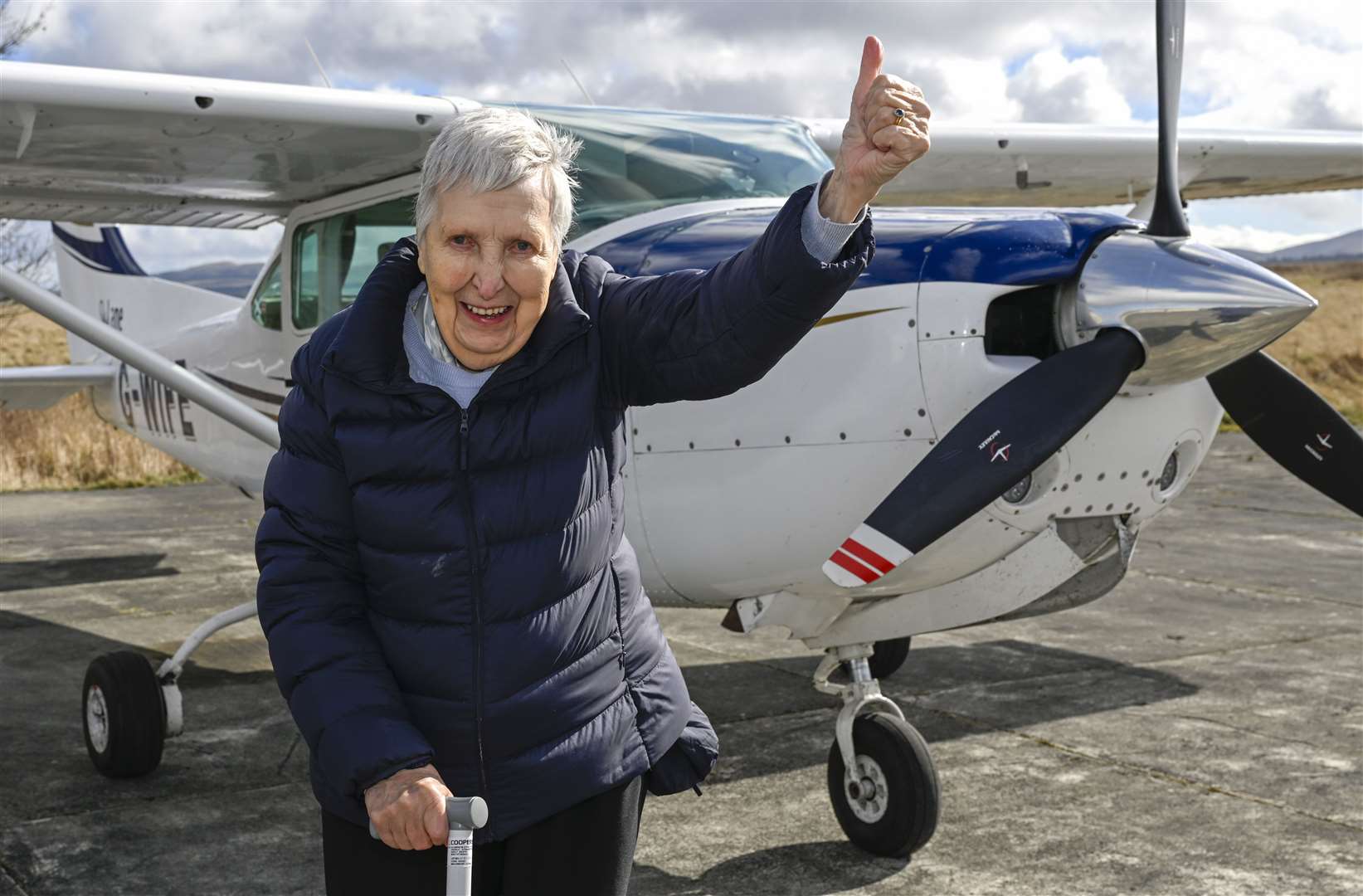 Betty Buckland gives a thumbs up beside the Cessna aircraft (Neil Hanna/Care UK/PA)