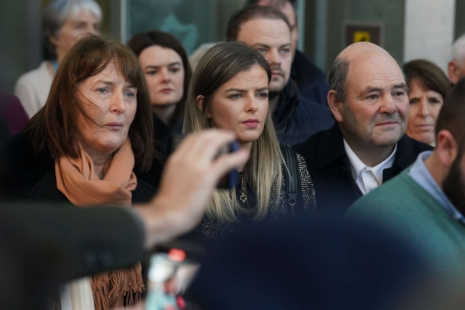 The parents of murdered teacher Ashling Murphy, Kathleen (left) and Raymond (right) and her sister Amy (centre) stand outside court (PA)