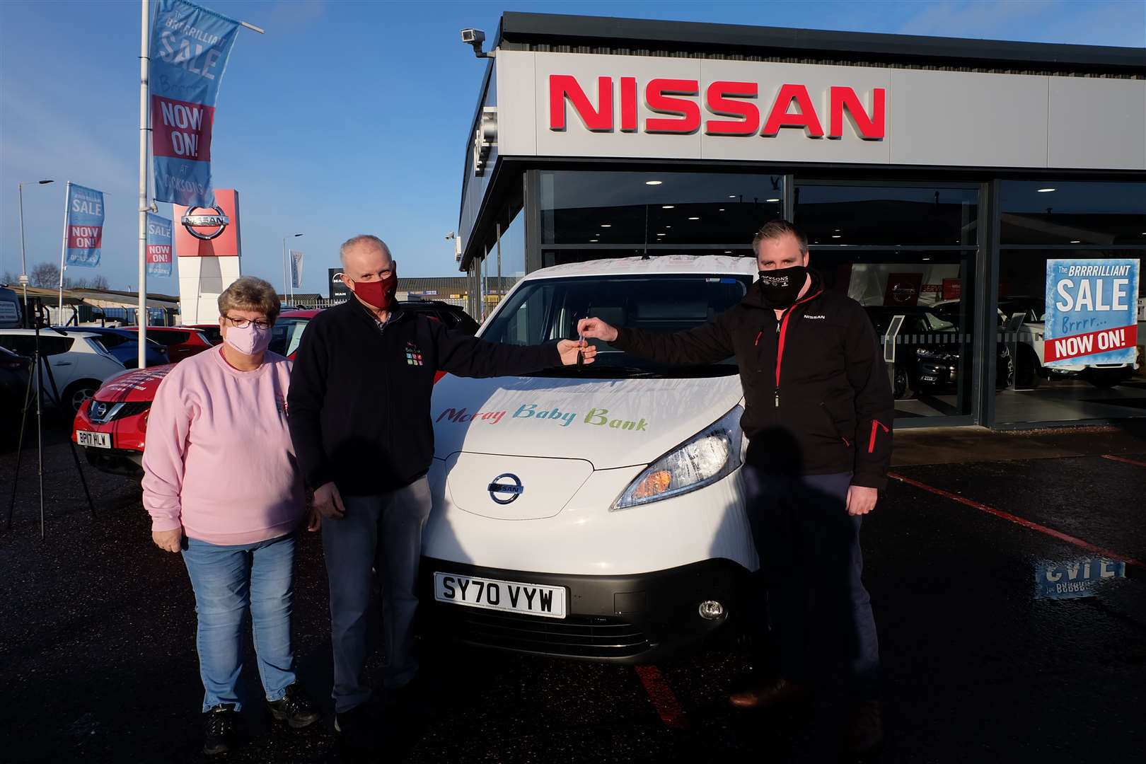 (From left) Moray Baby Bank co-founders Susan and Ian Sutherland collect the charity's electric van from Nissan sales manager Martin Montgomery, at Dicksons of Inverness.