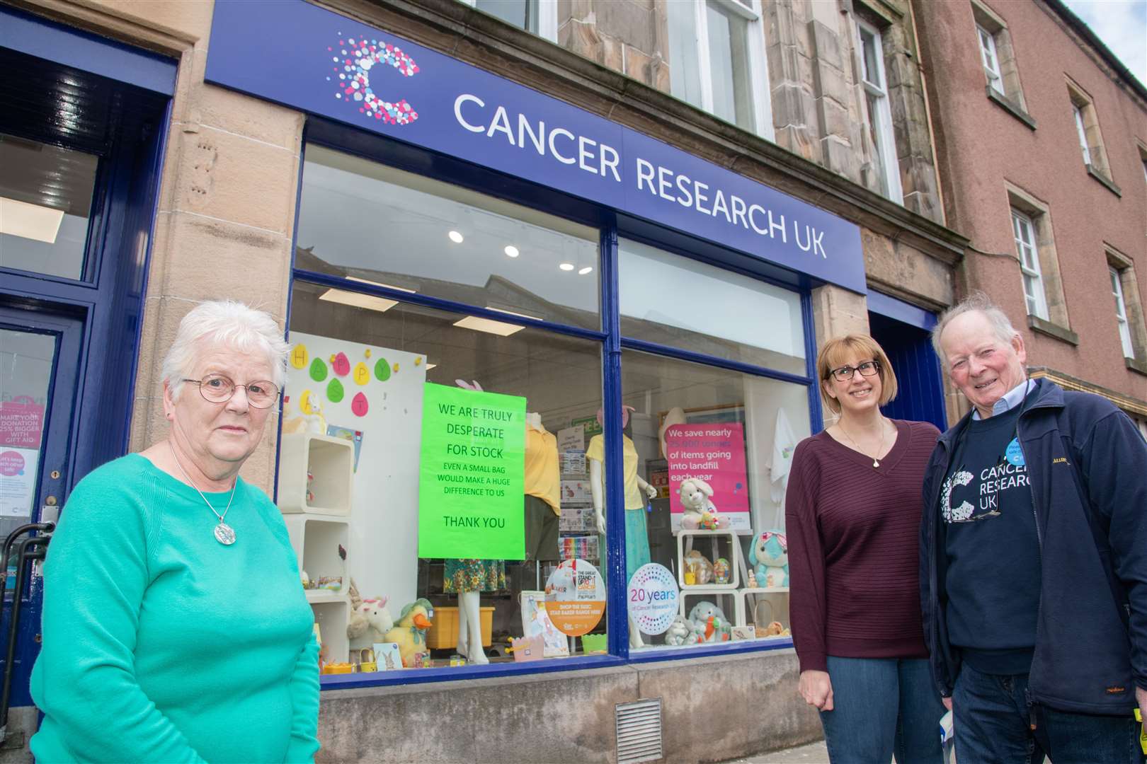 John MacKintosh (right) outside the Cancer Research Charity Shop in Elgin in 2022. Picture: Daniel Forsyth