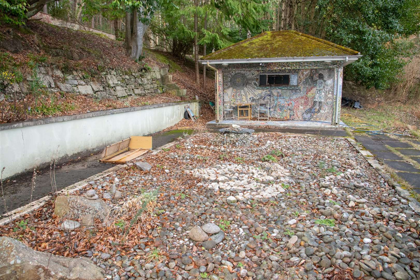 The former swimming pool and pool house at the back of the site.