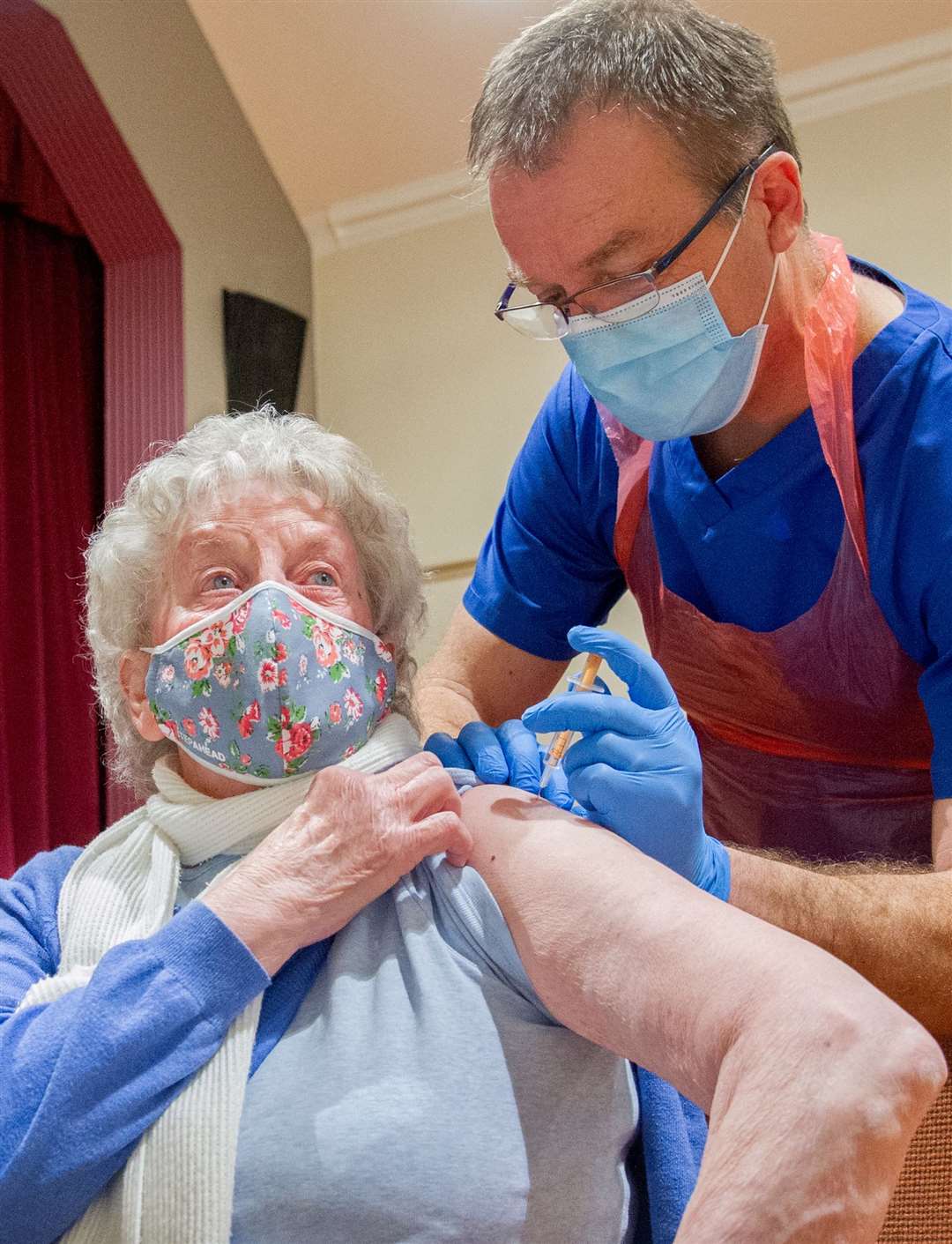 Ann Cumming receives the Covid-19 vaccine from senior practice nurse at Fochabers Medical Practice, Mike Brown, at the clinic held at Fochabers Public Institute on Wednesday. Picture: Daniel Forsyth.