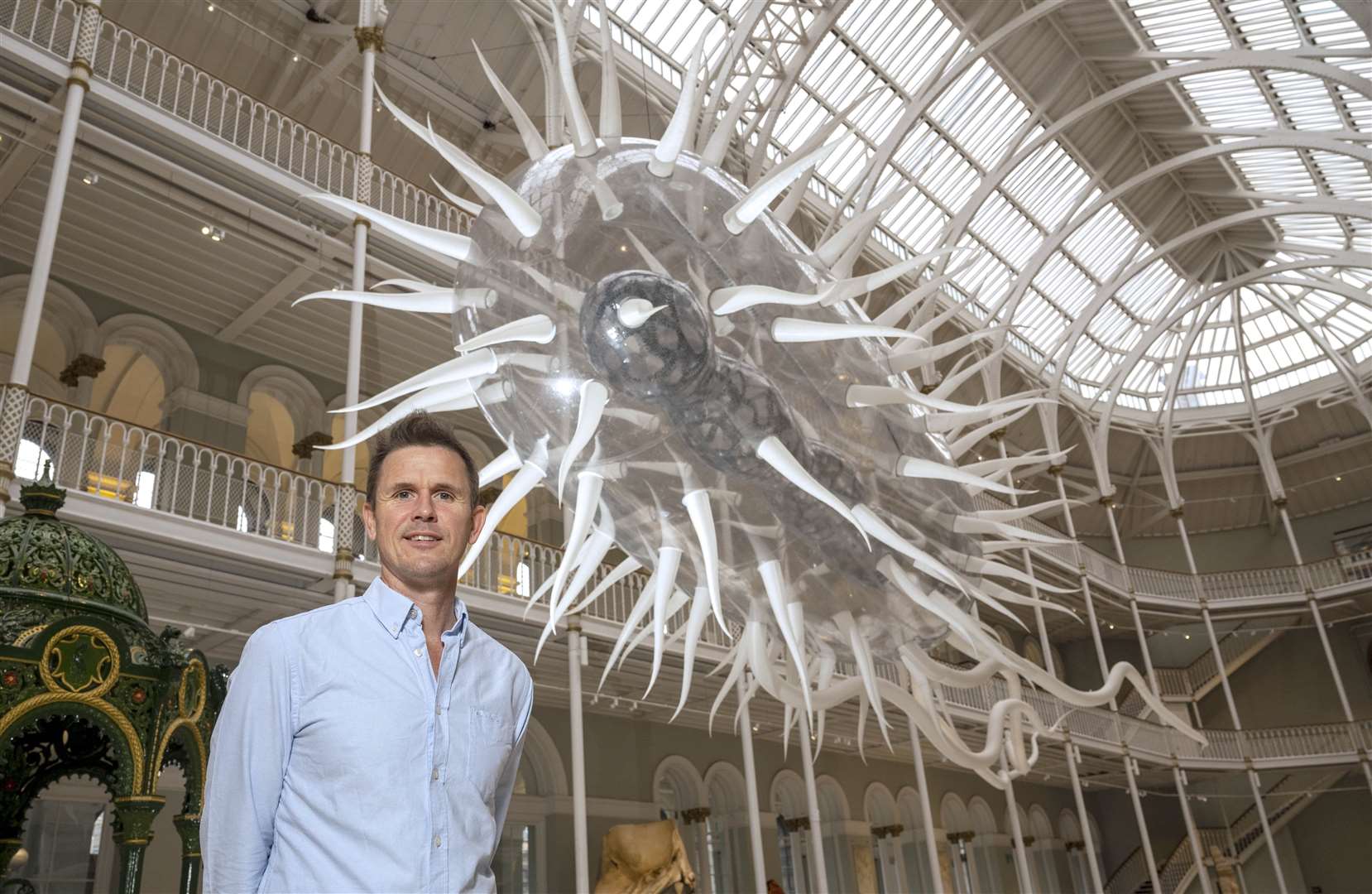 Artist Luke Jerram and his sculpture E.coli at the National Museum of Scotland (Neil Hanna/PA)