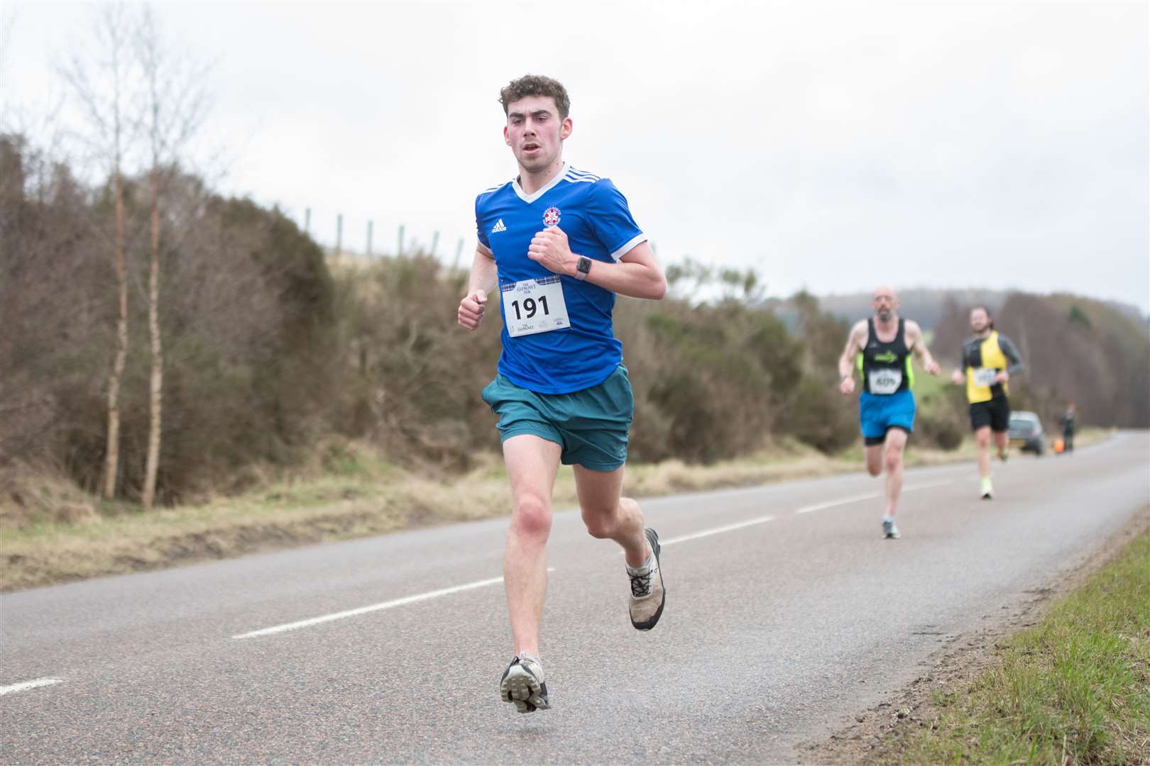 Running with his Lossiemouth FC top on, Jack Levy, who finished 11th overall with a time of 40:43...2023 Glenlivet 10k Race, which raises money for Chest Heart & Stroke Scotland. .. Picture: Daniel Forsyth..