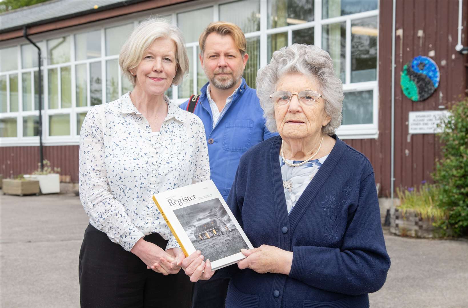 Margaret McKenzie (front) with Moira Dennis and Paul Heartfield with 'The Register'. Picture: Daniel Forsyth