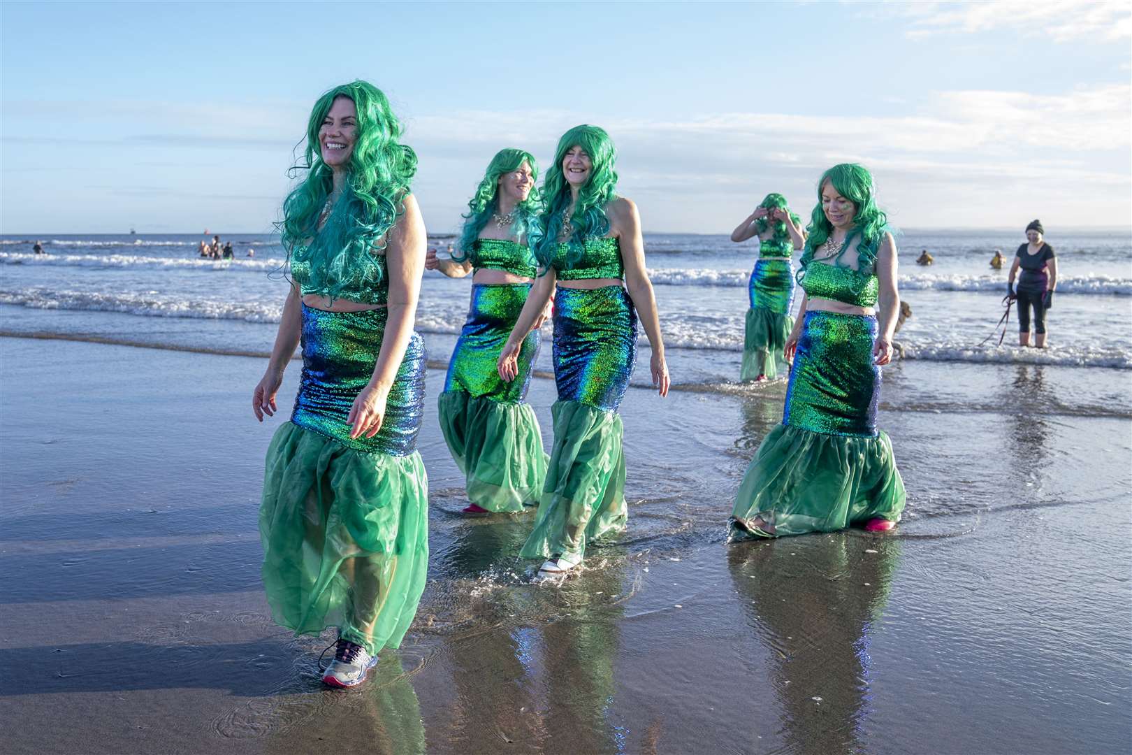 People take part in a Loony Dook New Year’s Day dip in the Firth of Forth at Kinghorn in Fife (Jane Barlow/PA)
