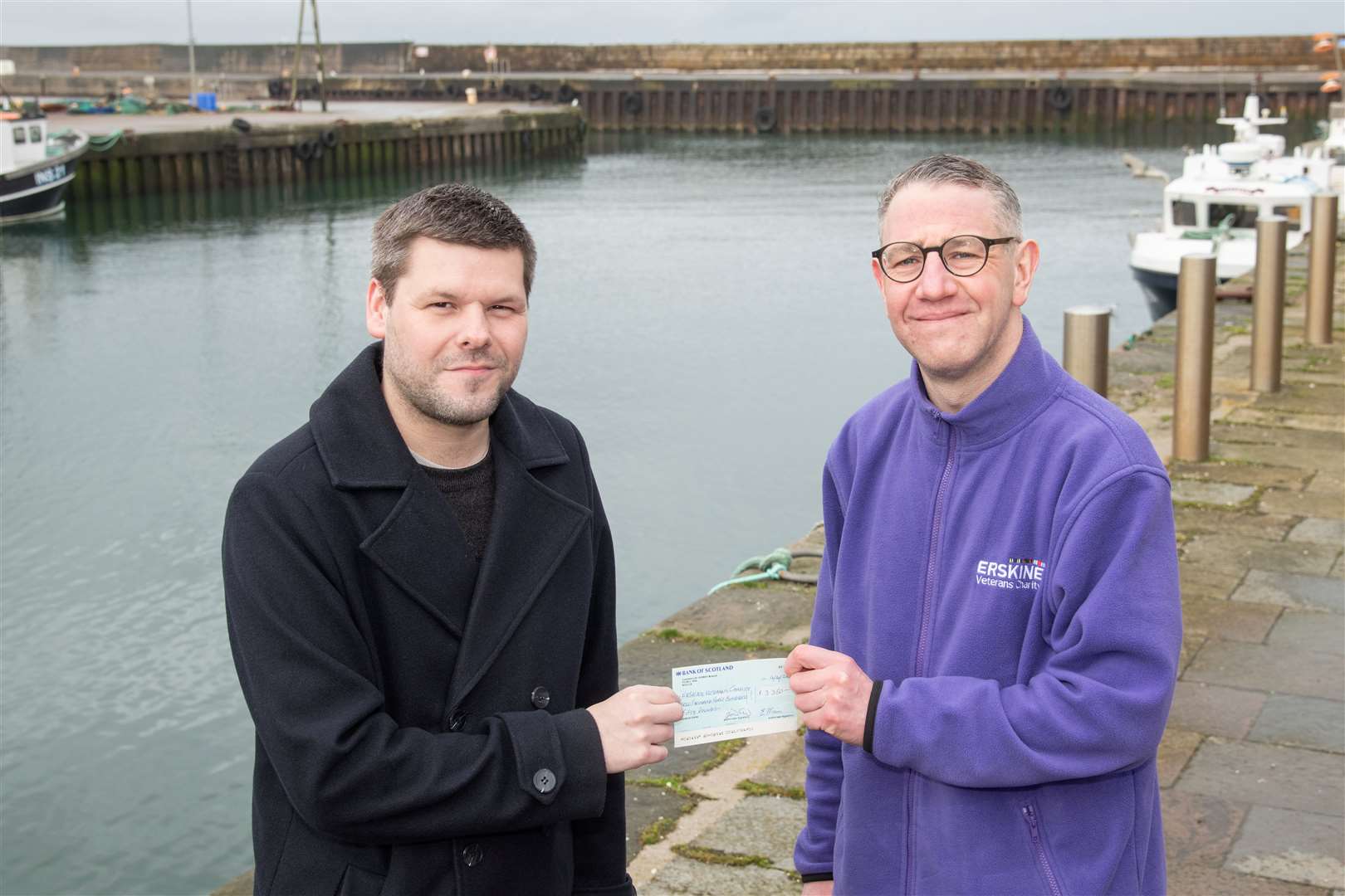 Erskine Forres’ Michael Parkes (right) receives a cheque from Jamie Campbell. Picture: Daniel Forsyth.
