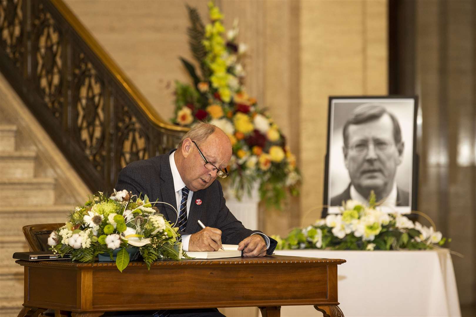 Jim Allister signing a book of condolence (Liam McBurney/PA)