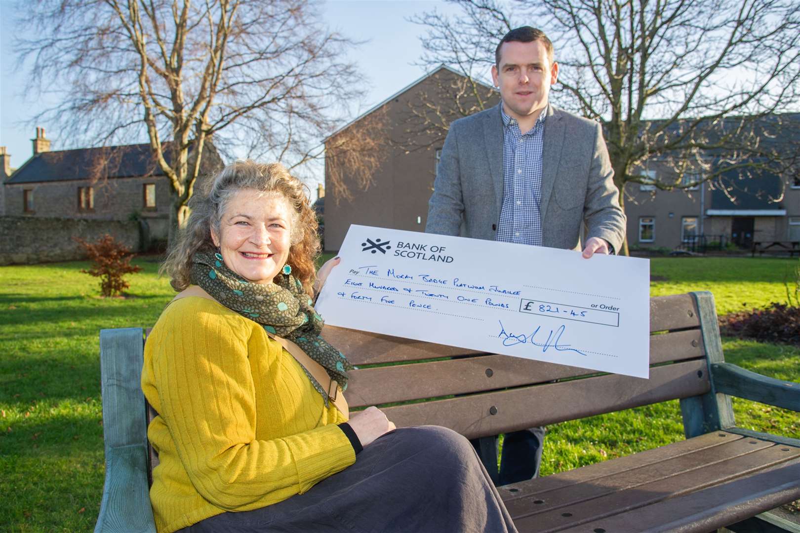 Douglas Ross hands a cheque over to Helen Moore of the Moray Badge Platinum Jubilee Project. Picture: Daniel Forsyth.