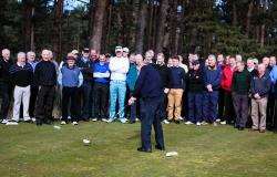 Forres Golf Club's Mens Captain tees off the opening drive with members looking on