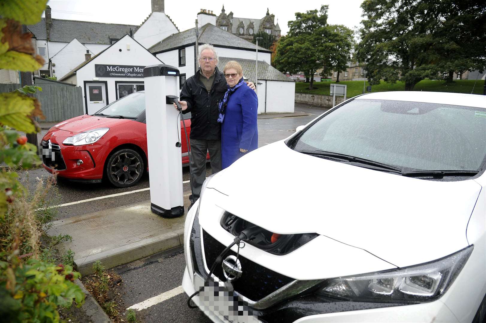 Derek and Janis Thompson at the electric parking bays on Leask Road which is always occupied by non electric cars...Picture: Becky Saunderson..