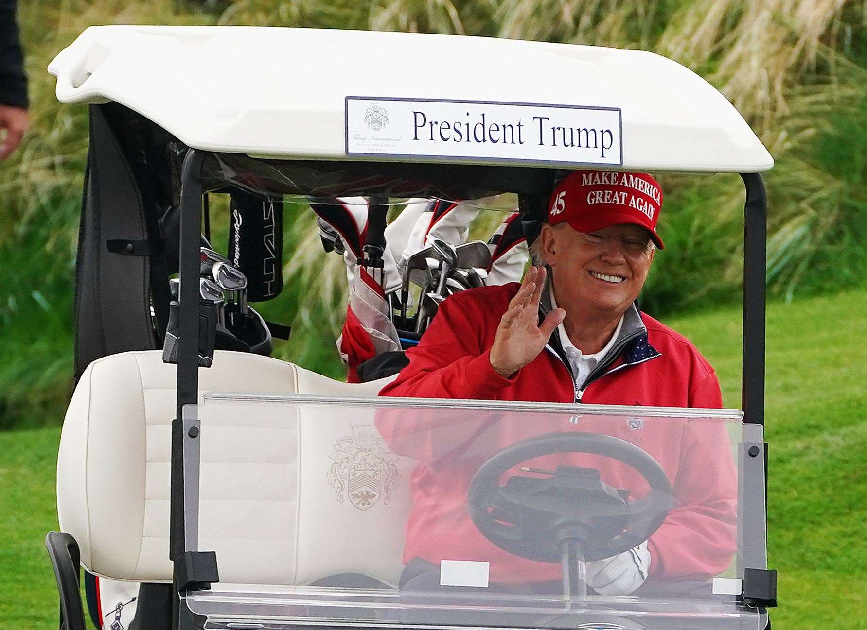 Former US president Donald Trump makes his way to the fourth tee (Brian Lawless/PA)