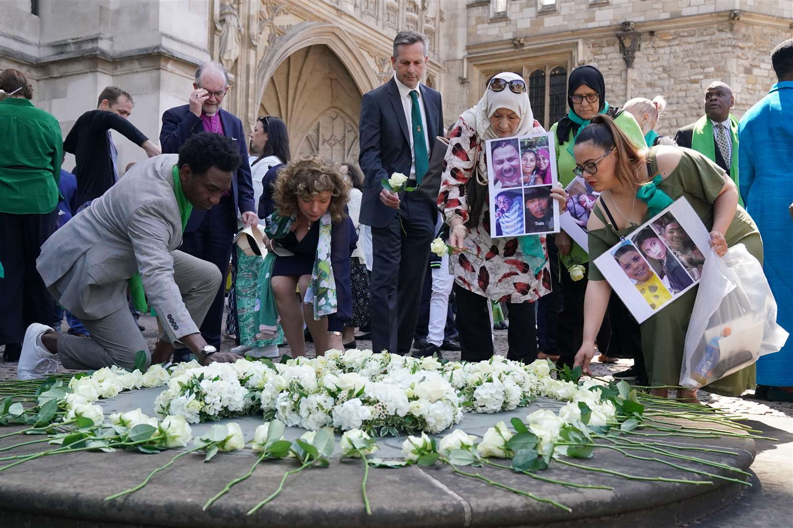 Outside the abbey, people placed white roses in memory of the victims (Jonathan Brady/PA)
