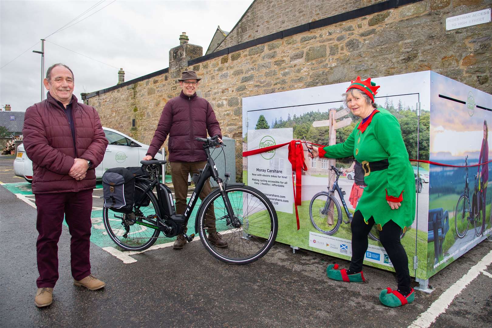 Forres Councillor Lorna Creswell (Right) is joined by Alastair Kennedy (Left) Chairman of the LEADER Local Action Group and Gordon McAlpine (Centre) Manager of Moray Car Share at the offical launch of the new electric bike shelter at Tulloch Car Park, Forres...Picture: Daniel Forsyth..