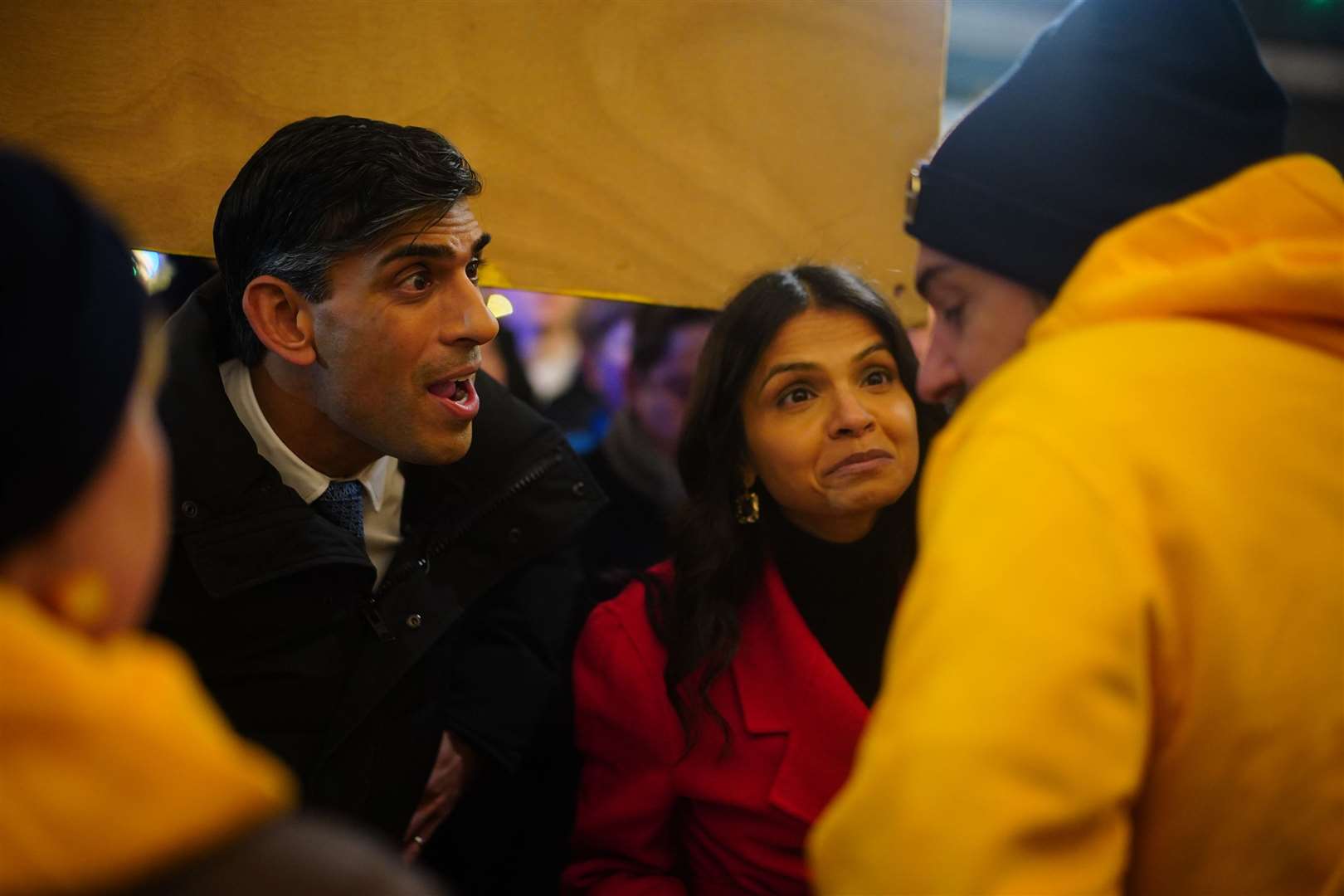 Prime Minister Rishi Sunak and his wife Akshata Murty, speak to guests at the switching on of the Downing Street Christmas tree lights in London (Victoria Jones/PA)