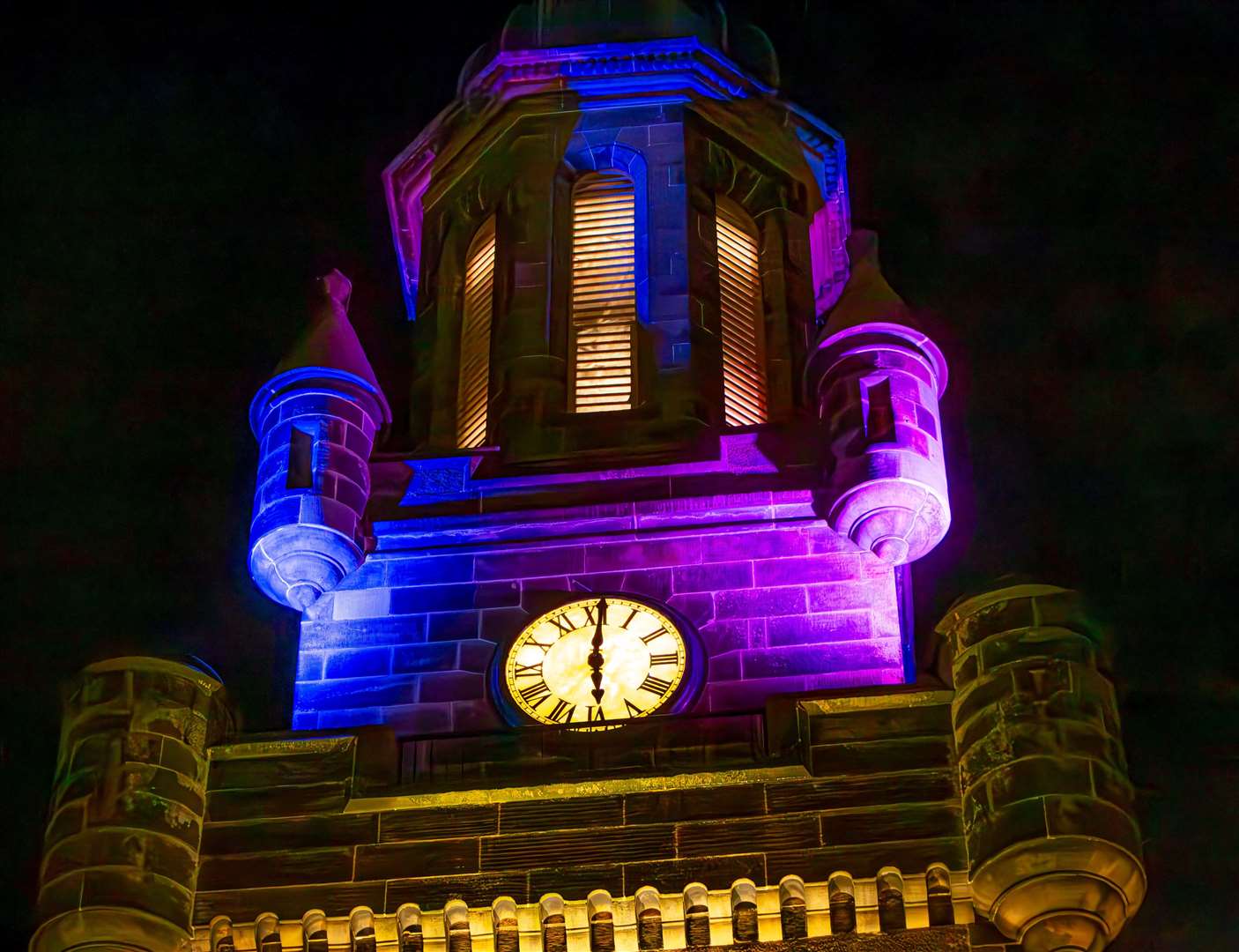 The illuminated clocktower.