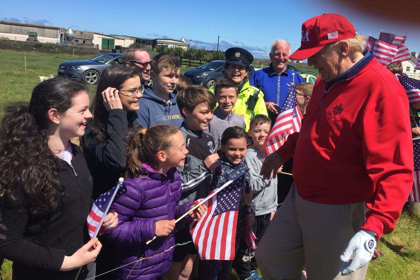 Residents, pupils and teachers from Clohanes National School meet US President Donald Trump at his golf resort in Doonbeg (Handout/PA)