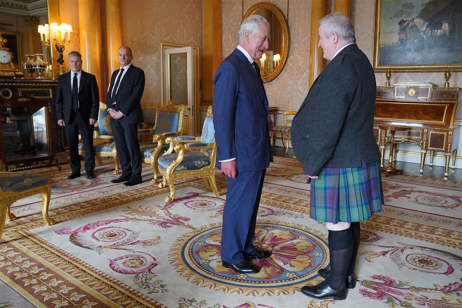 The King speaks with SNP Westminster leader Ian Blackford, watched by Labour leader Sir Keir Starmer (far left) and Liberal Democrat leader Sir Ed Davey during an audience with opposition leaders in the 1844 Room, at Buckingham Palace (Jonathan Brady/PA)