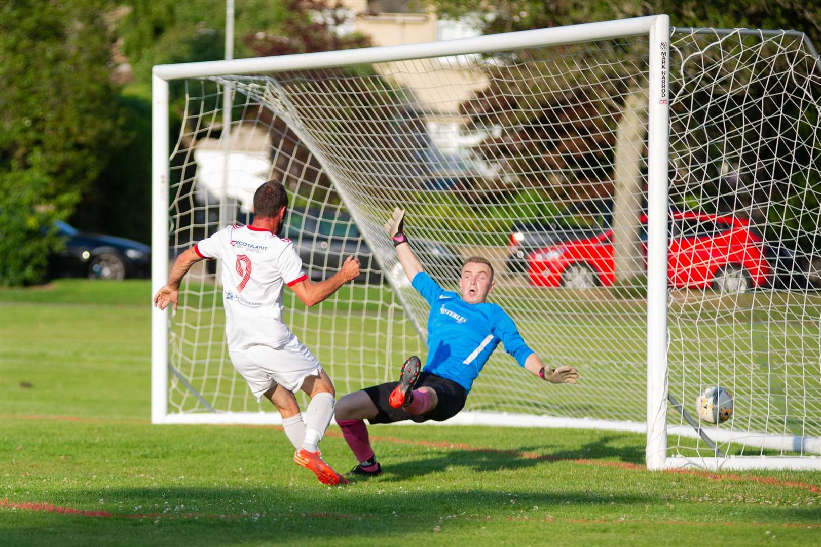 Carisbrooke's Ricky Wardrop scores the only goal of the match past Westerlea's Kyle Mallinson...Carisbrooke FC (1) vs Westerlea FC (0) - Top Car Cup Final - Roysvale, Forres 16/07/2021...Picture: Daniel Forsyth..