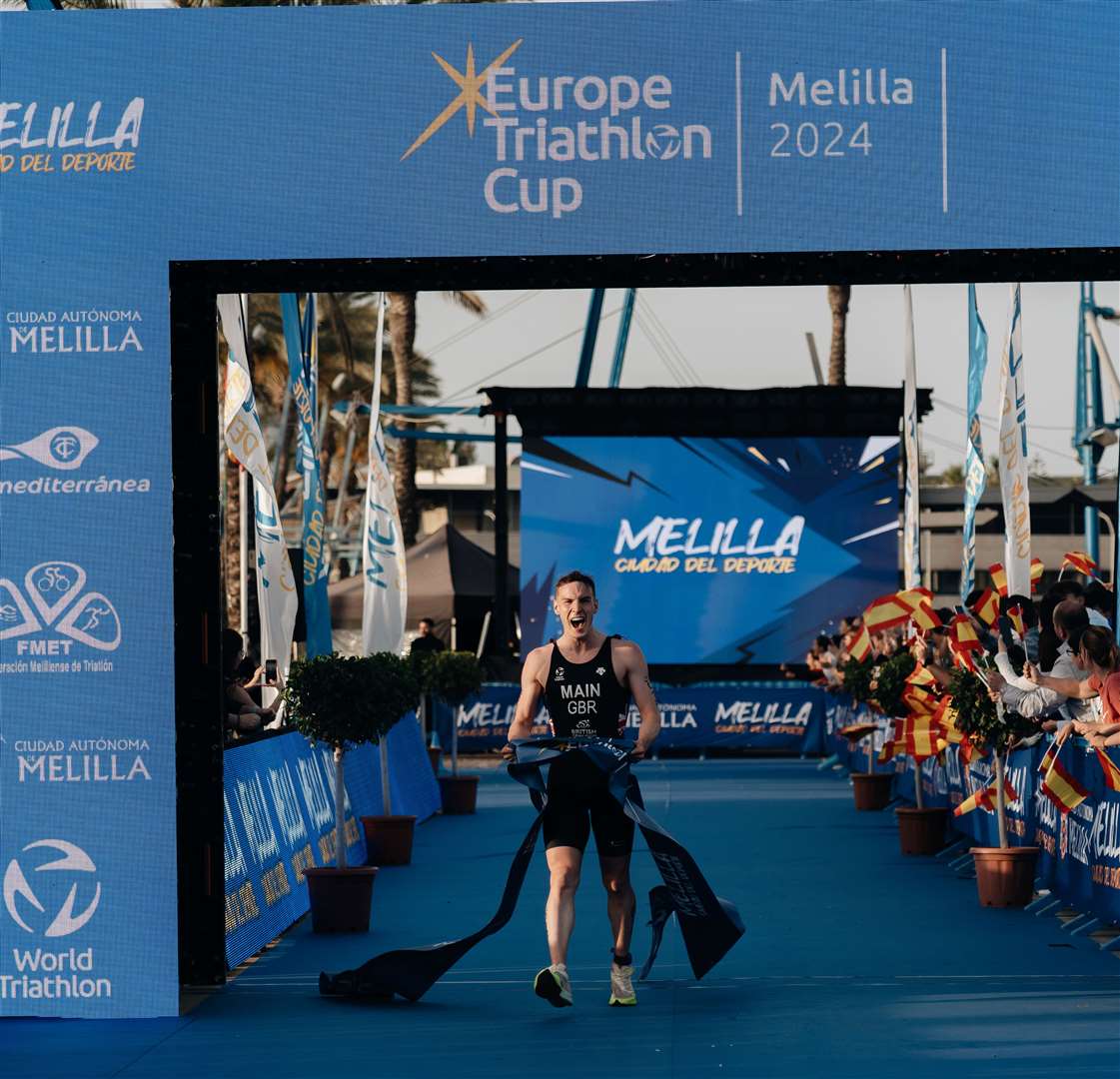 Cameron Main breaks the tape to win the Europe Cup race in Melilla.