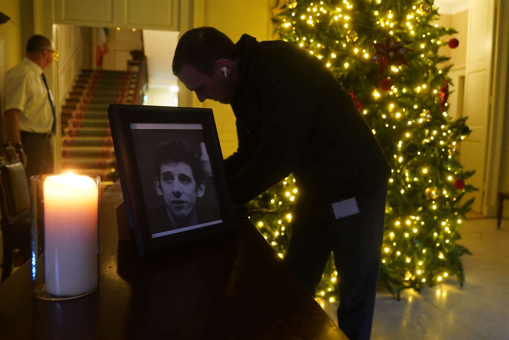 A candle burns next to a photograph of The Pogues frontman Shane MacGowan at the Mansion House, in Dublin (Brian Lawless/PA)