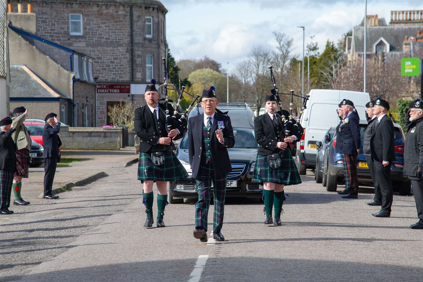 Albert Duffus and pipers Johnathan Scott and Emma Lawrence lead the way...The funeral procession is led along Tytler Street as 100-year-old war veteran Donald Smith is laid to rest..Picture: Daniel Forsyth..