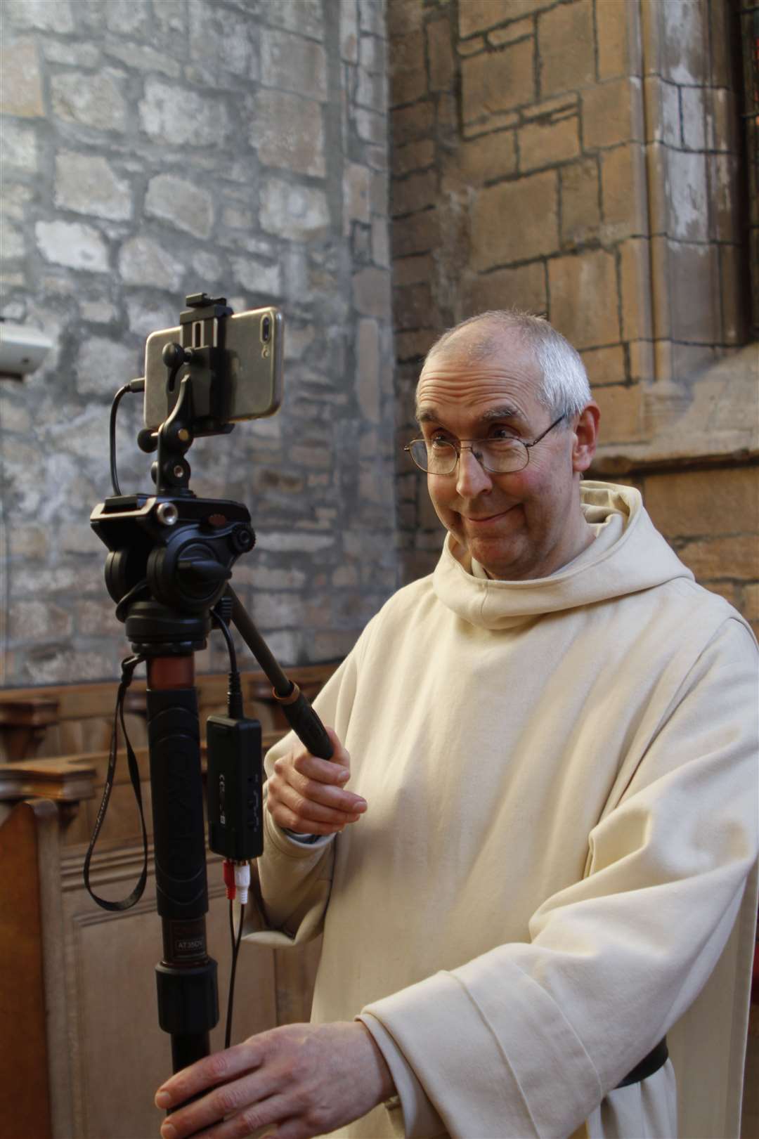 Brother Michael de Klerk adjusting one of the cameras for one the Abbey's live online services.
