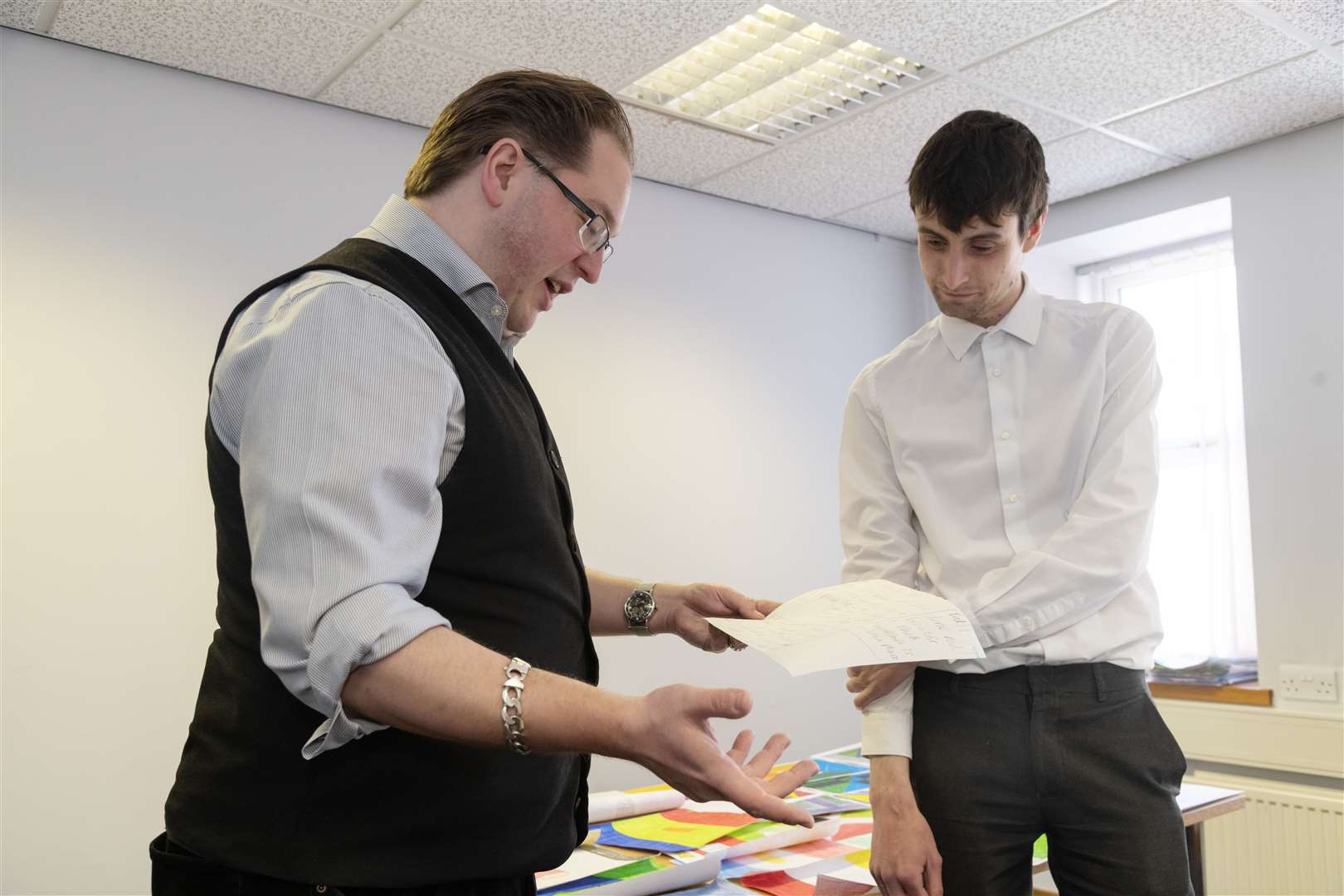 Vexilloligst Philip Tibbetts and Forres Gazette reporter Jonny Clark casting an eye over entries for the Moray and Banffshire flag competition. Picture: Beth Taylor