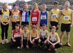 Anna MacFadyen and Ben Cameron in their red Harriers shirts with the other North District runners.