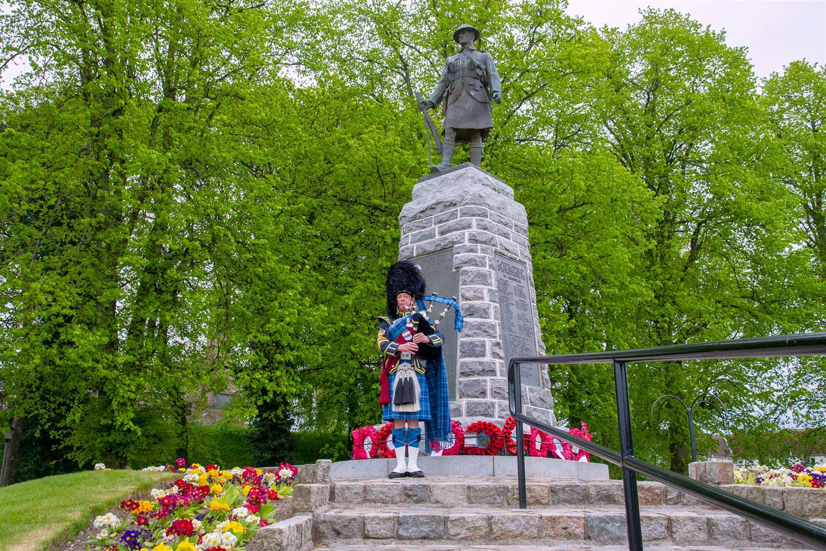 Pipe Major Barry Ashby of RAF Lossiemouth Pipe Band playing in Remembrance at the Forres War Memorial.