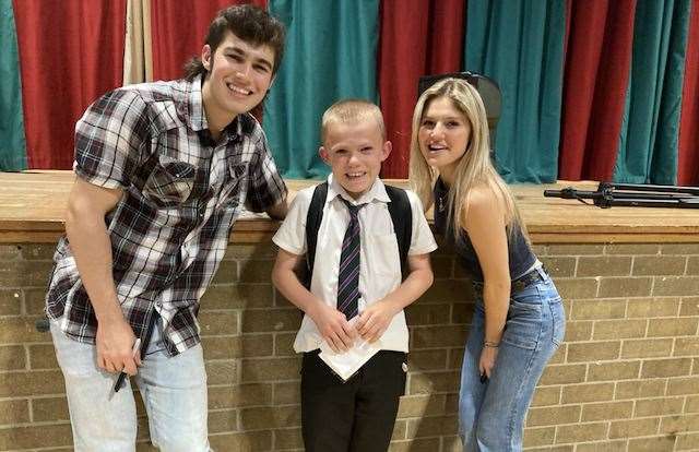 S1 pupil Travis Bremner meeting Juna N Joey off stage in Forres Academy’s assembly hall.
