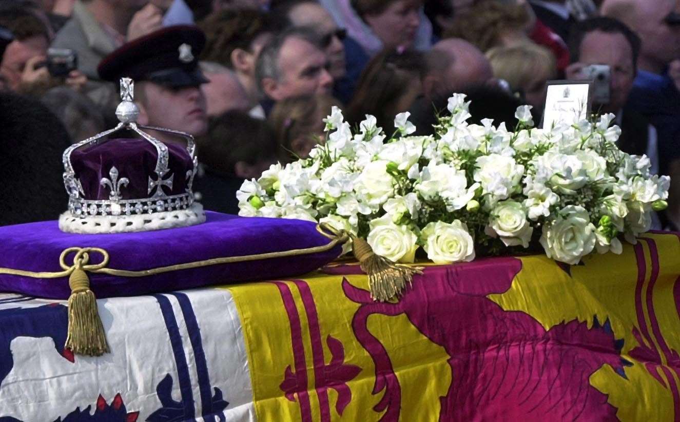 The Queen Mother’s crown, containing the Koh-i-noor diamond, rests on her coffin on a gun carriage pulled by the Royal Horse Artillery in April 2002 (Rebecca Naden/PA)