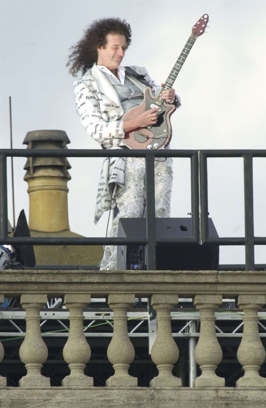 Queen guitarist Brian May plays the national anthem from the roof of Buckingham Palace to start the second concert to commemorate the Queen’s Golden Jubilee (Stefan Rousseau/PA)