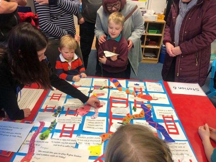 The children made a snakes and ladders board to teach the community about rights at the community event.