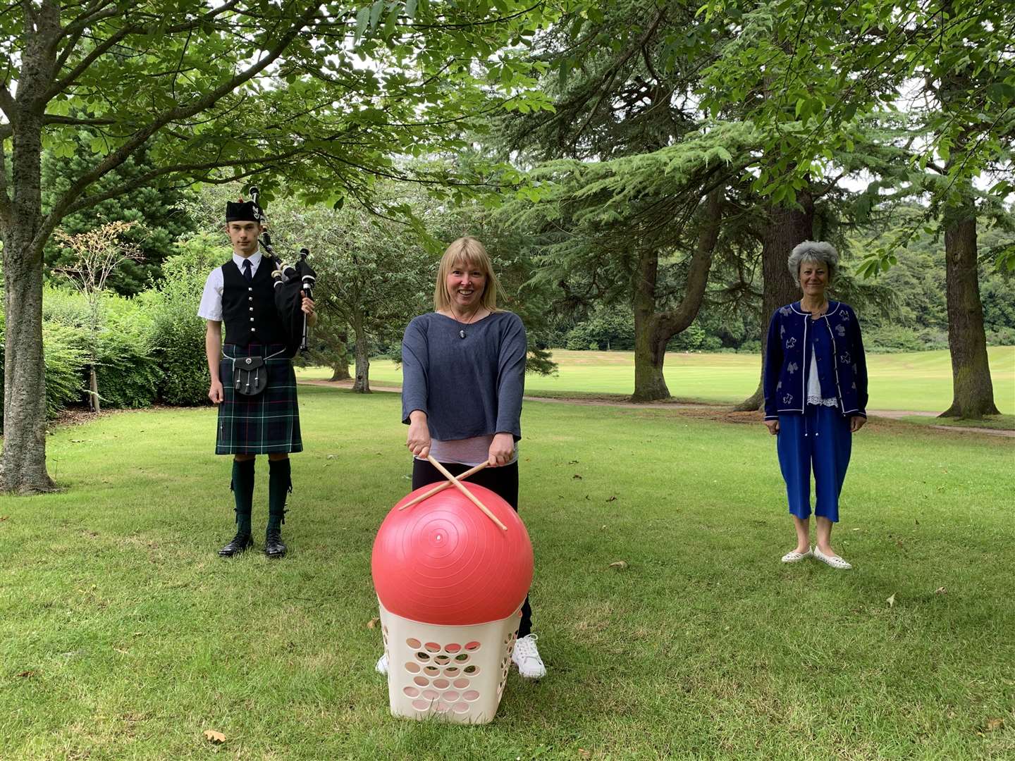 Calum Robertson from the Forres and District Pipe Band, Sharon Finlay from Active Minds Moray and Christine Grant from the Forres branch of the Royal Scottish Country Dancing Society.
