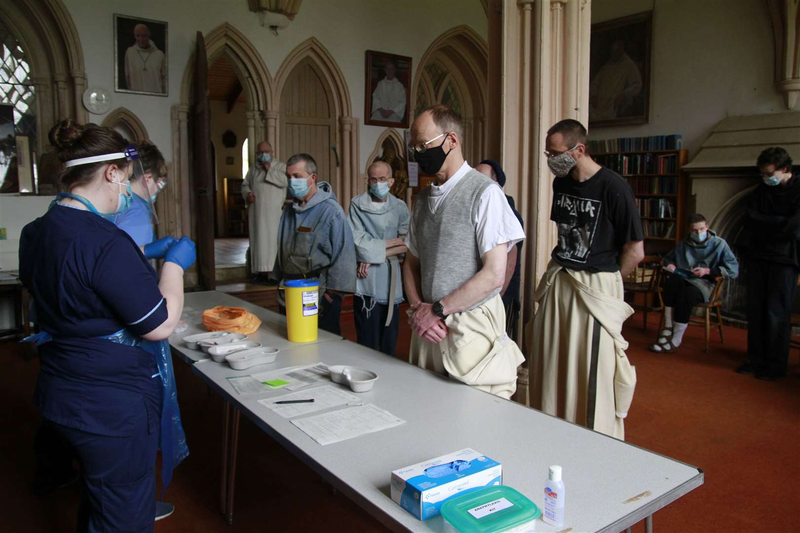 Monks lining up for their Covid-19 vaccinations at Pluscarden Abbey.