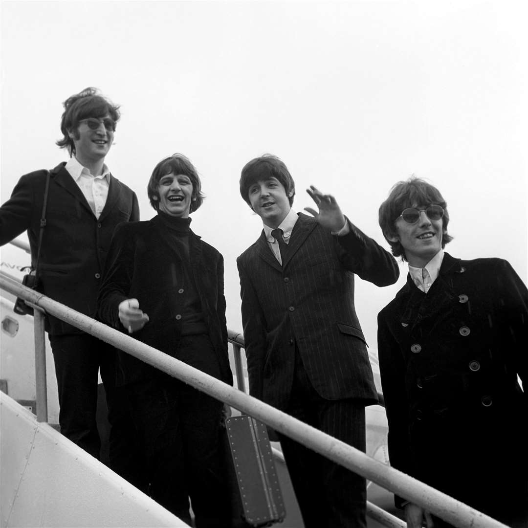 Beatles John Lennon, Ringo Starr, Paul McCartney and George Harrison as they boarded a plane in London in 1966 (PA)