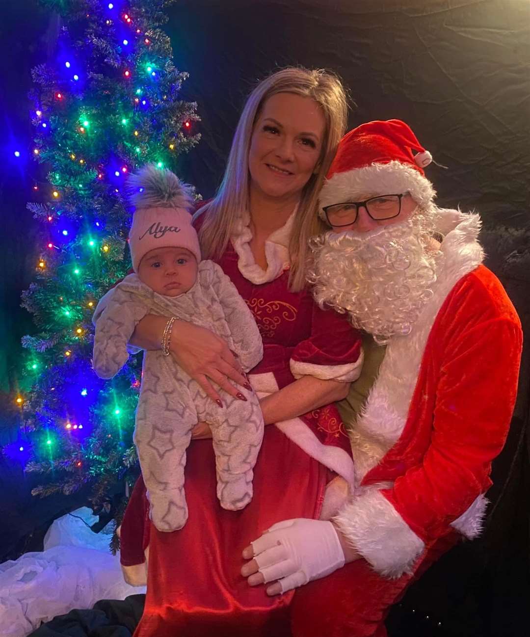 Lynnie and Santa with her granddaughter Ayla.