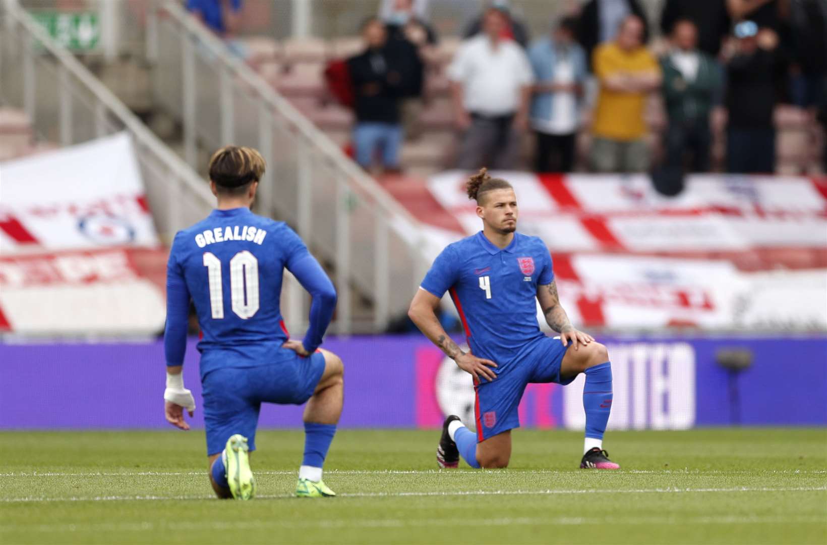 England’s Jack Grealish and Kalvin Phillips take a knee before the international friendly match against Romania last month (Lee Smith/PA)