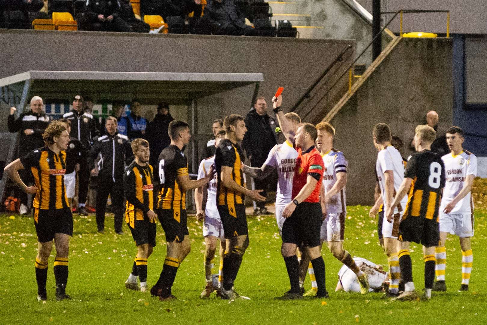 Referee Chris Fordyce gives Huntly centre back Michael Clark his marching orders. Picture: Daniel Forsyth..
